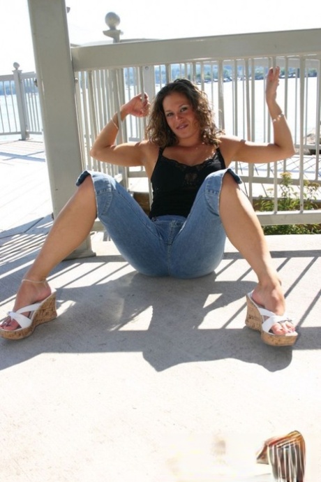 Amateur girl poses non nude on a balcony in denim capris 11113805